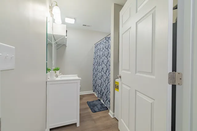 a bathroom with a sink a toilet and a mirror
