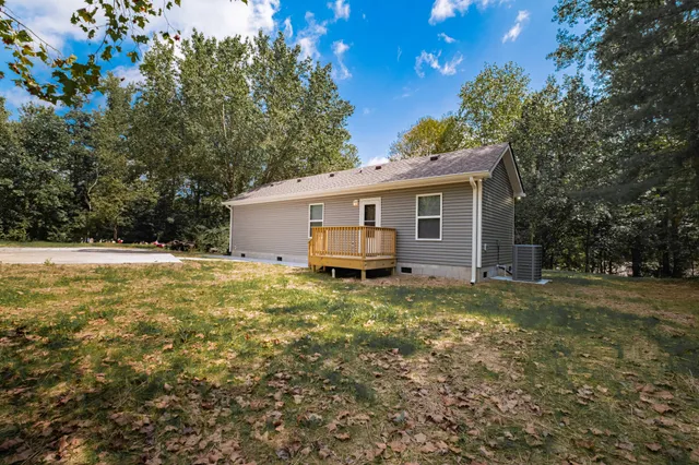 a front view of house with yard and trees
