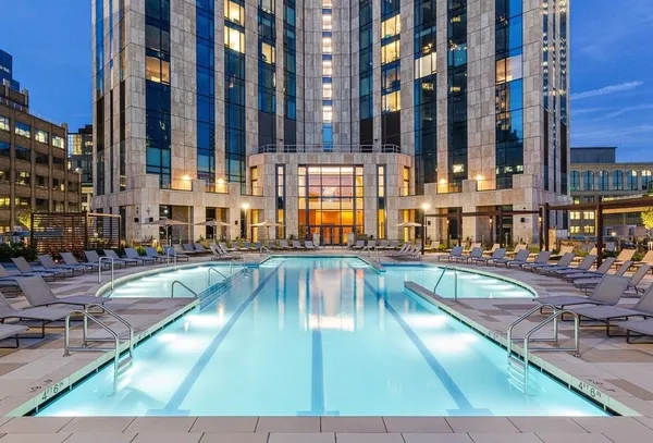 a view of a swimming pool with outdoor seating