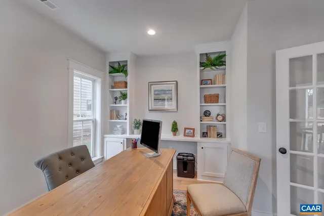 a living room with fireplace furniture and a large window