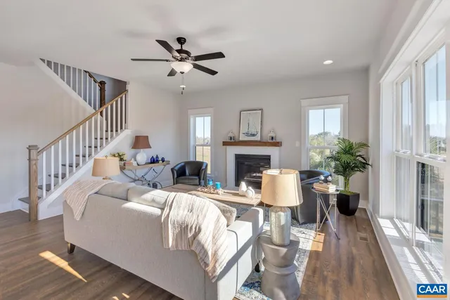 a living room with furniture fireplace and a large window