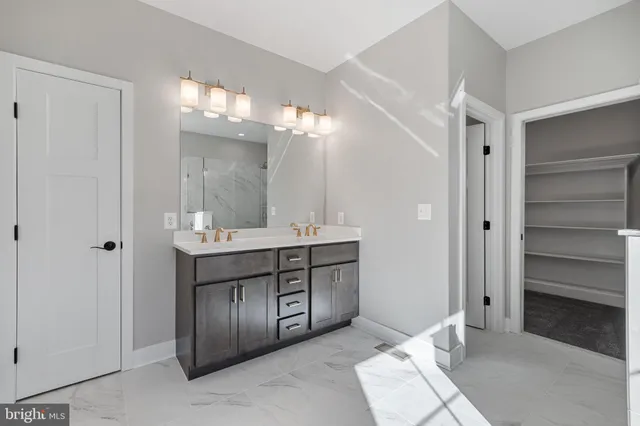 a bathroom with a double vanity sink and a mirror