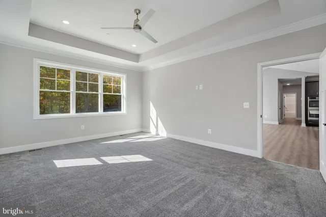 an empty room with windows and closet area