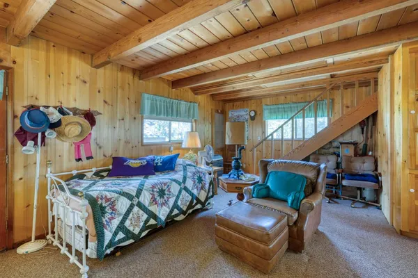 a bedroom with furniture and a window