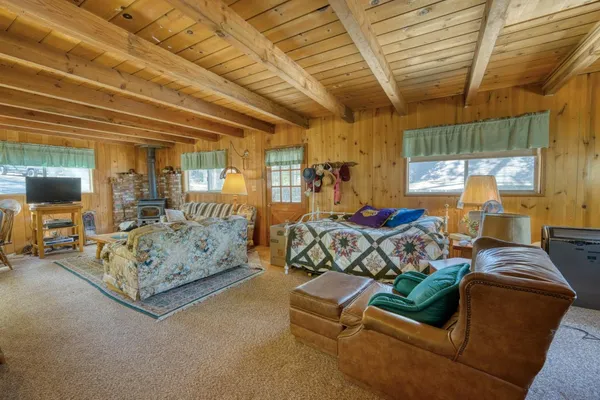 a bedroom with furniture and a large window