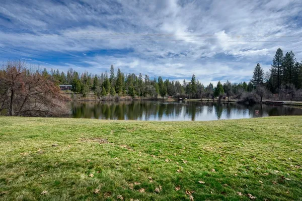 a view of a lake with houses in the back