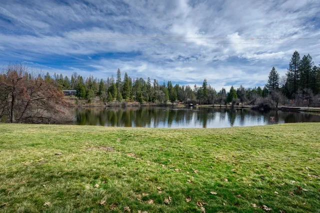 a view of a lake with houses in the back