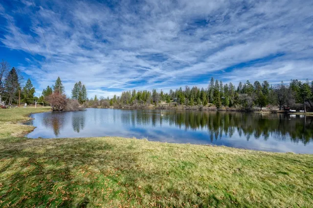 a view of a lake with houses in the back
