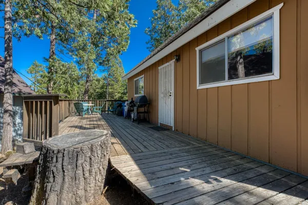 a view of backyard with deck and wooden floor