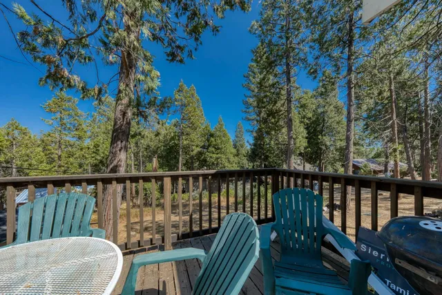 a view of a balcony with wooden floor and outdoor seating