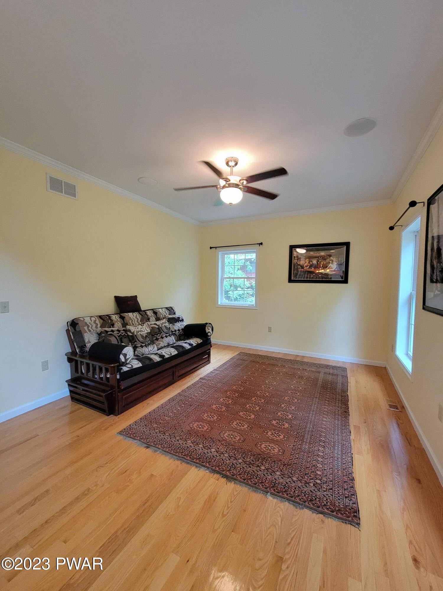 110 Rodeo Lane Hawley, PA 18428 - Photo 9 of 36 a living room with hard wood floor and a chandelier