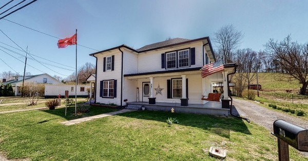 419 East Main Street Red Boiling Springs, TN 37150 - Photo 4 of 44 a front view of a house with a yard table and chairs