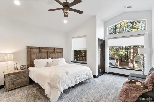 a bedroom with a bed and glass window