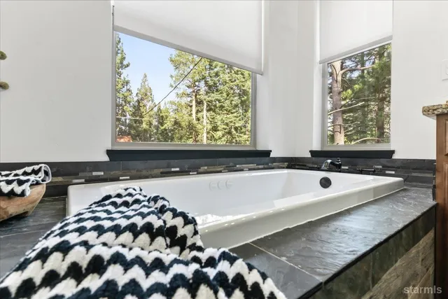 a bath tub sitting in a bathroom next to a window