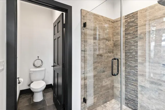 a bathroom with a toilet and a shower