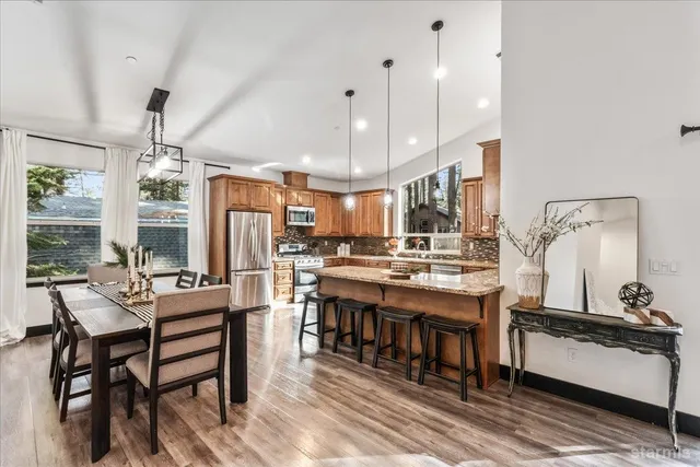 a room with lots of wooden furniture and a chandelier