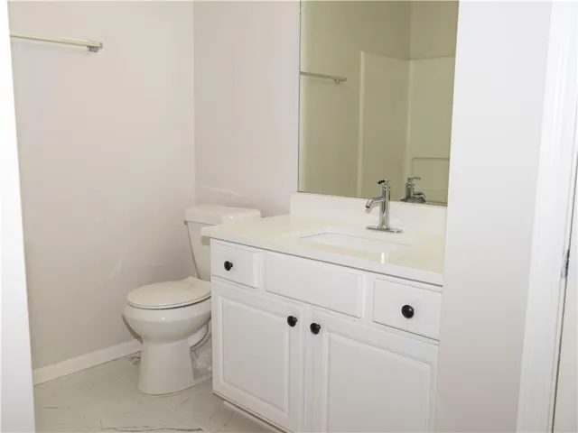 a bathroom with a sink toilet and vanity