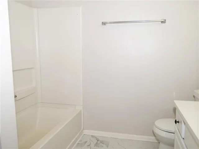 a bathroom with a shower and a toilet