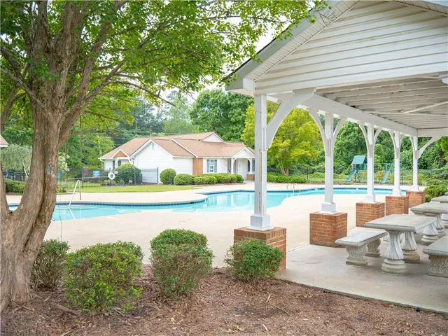 a view of swimming pool with seating area and roof