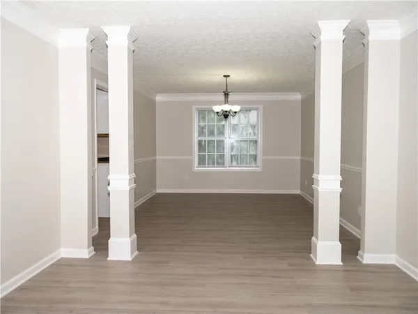 a view of empty room with wooden floor and fireplace