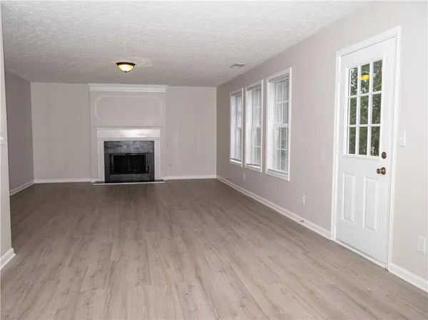 a kitchen with a sink cabinets and wooden floor