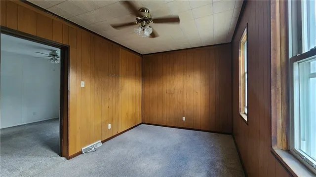 a view of a livingroom with a ceiling fan and window