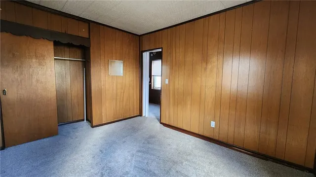 a view of an empty room with wooden walls