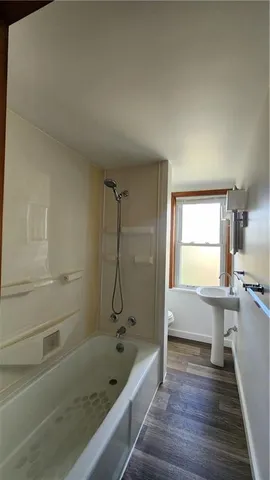 a bathroom with a sink a toilet and bathtub