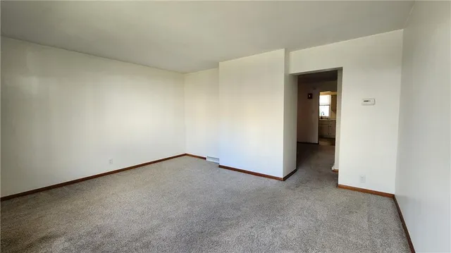 a view of an empty room and a window