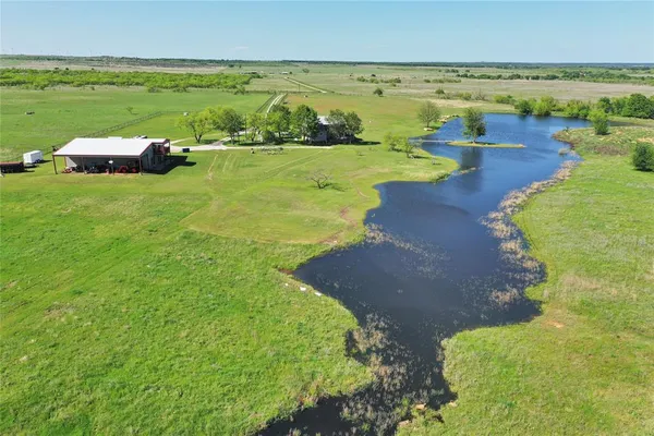 a view of a lake with a yard
