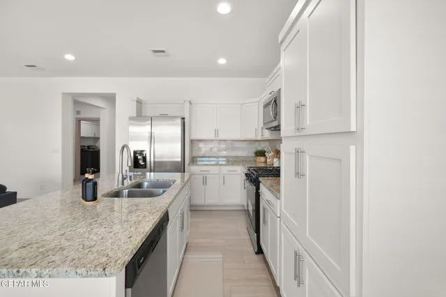 a kitchen with refrigerator and cabinets