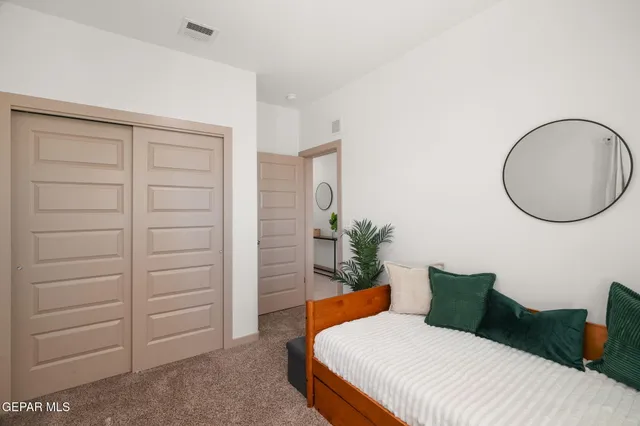 a bedroom with a bed and a dresser