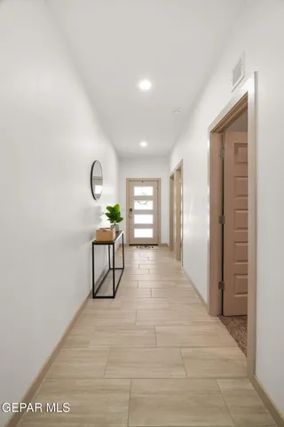 a view of a hallway with wooden floor and a large window