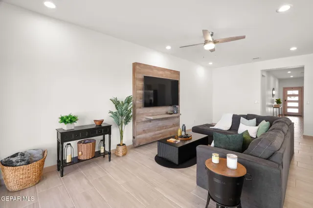 a living room with furniture and a wooden floor