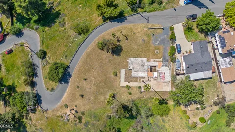 an aerial view of residential house with green space