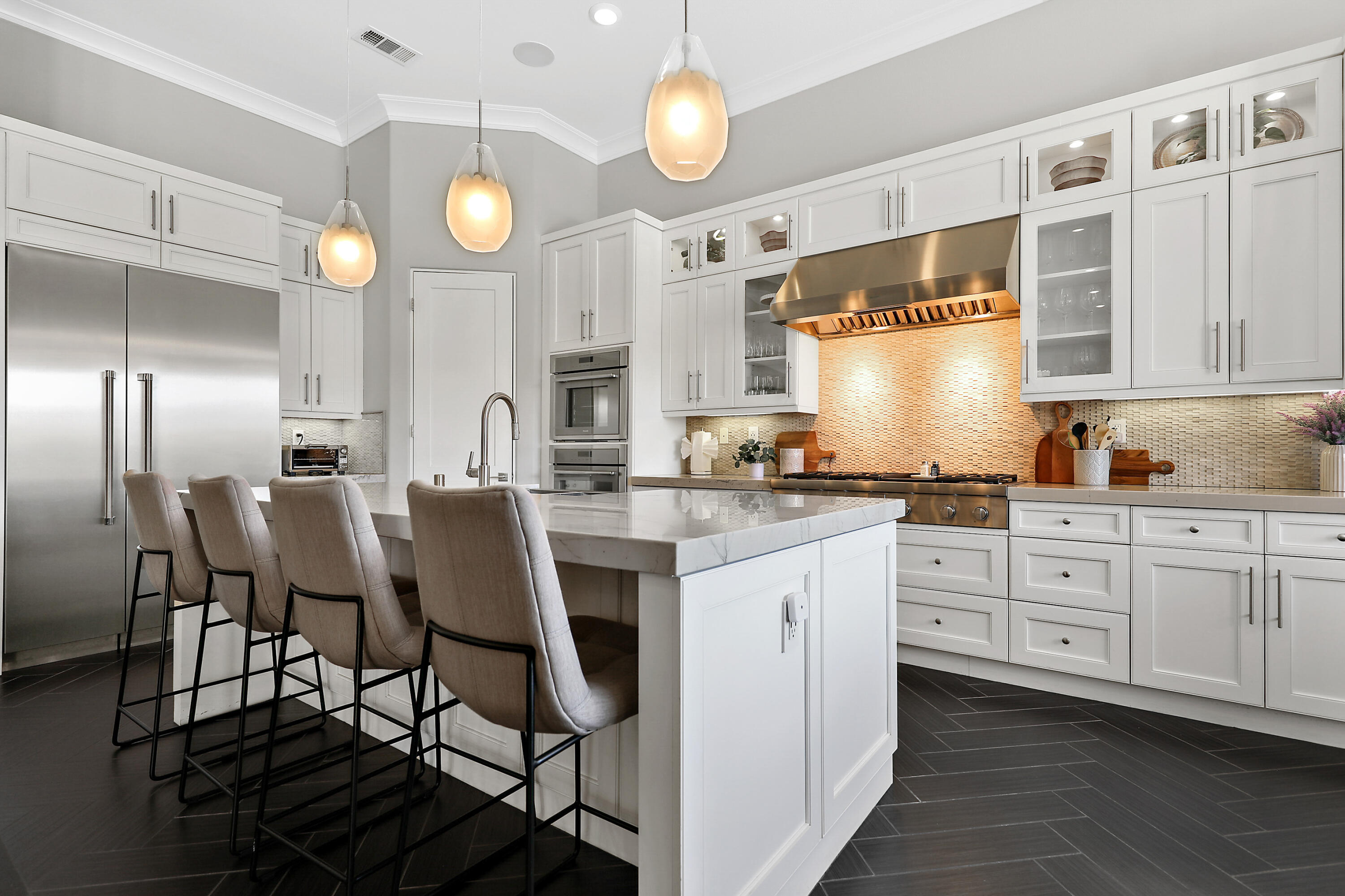 54820 Aristides Court La Quinta, CA 92253 - Photo 11 of 62 a kitchen with cabinets and chairs