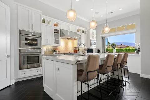 a kitchen with white cabinets and a stove
