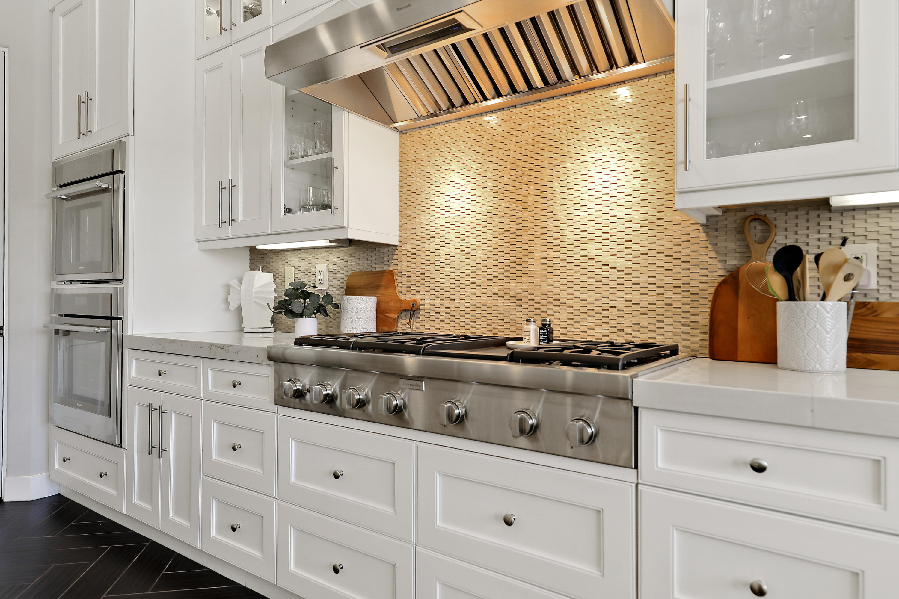 54820 Aristides Court La Quinta, CA 92253 - Photo 13 of 62 a kitchen with white cabinets and a stove
