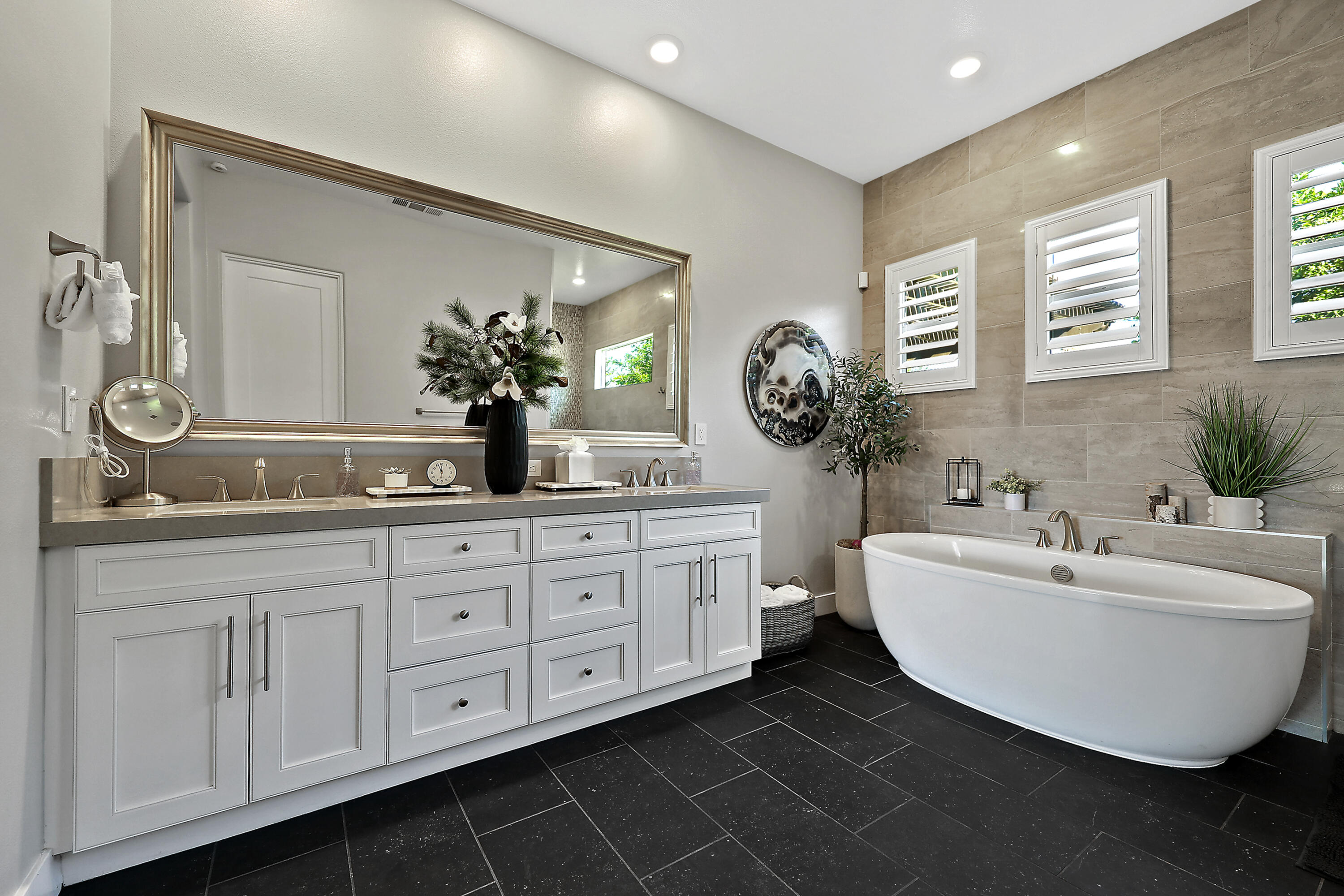 54820 Aristides Court La Quinta, CA 92253 - Photo 20 of 62 a bathroom with a double vanity sink a mirror and bathtub