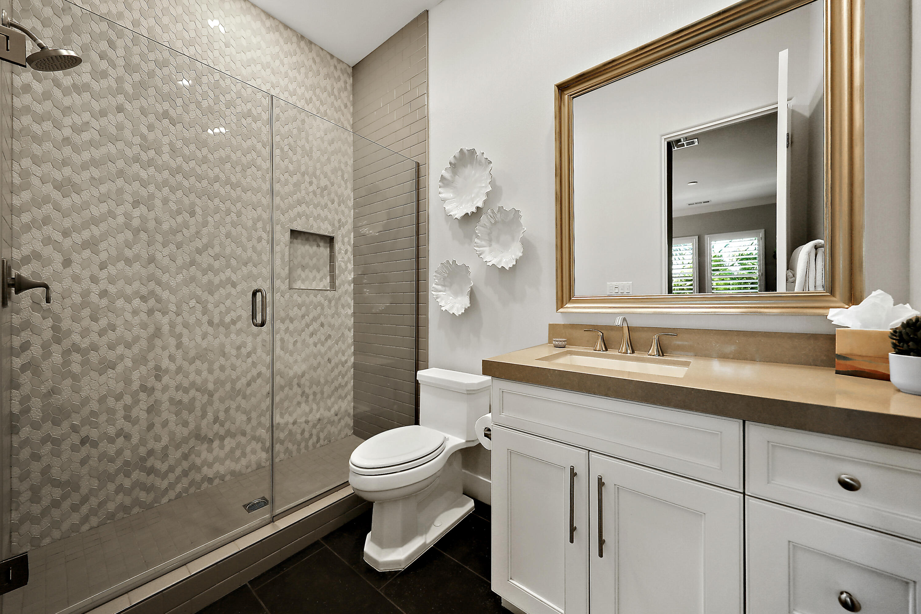 54820 Aristides Court La Quinta, CA 92253 - Photo 26 of 62 a bathroom with a granite countertop sink a toilet and a mirror