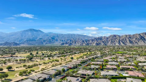 a dining hall with lots of tables a large window and stainless steel appliances
