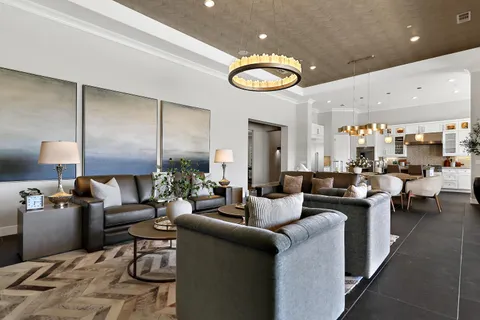 a living room with fireplace furniture and a large window