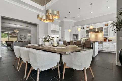 a kitchen with cabinets and chairs