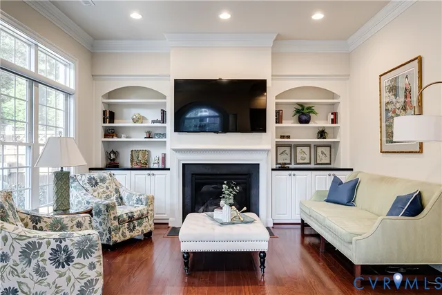 a living room with furniture fireplace and flat screen tv