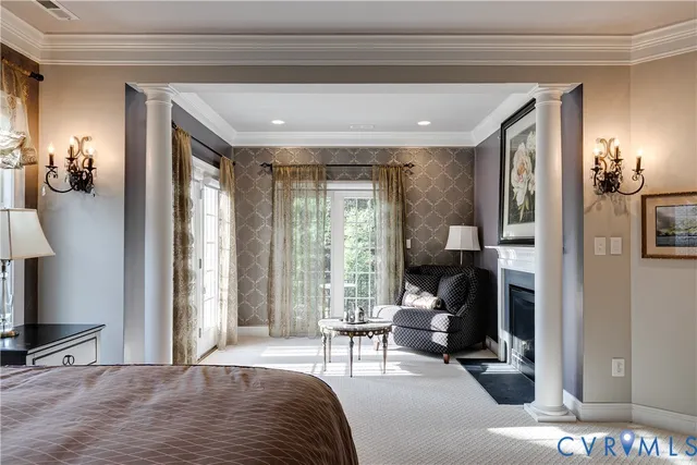 a bedroom with a bed and large windows