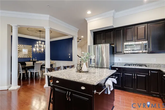 a living room with furniture a fireplace and a large window