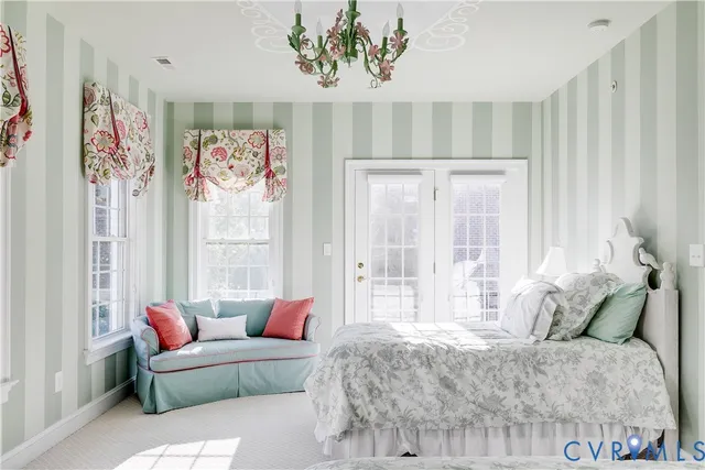 a bedroom with furniture and a large window