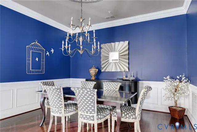 a view of a dining room with furniture and chandelier