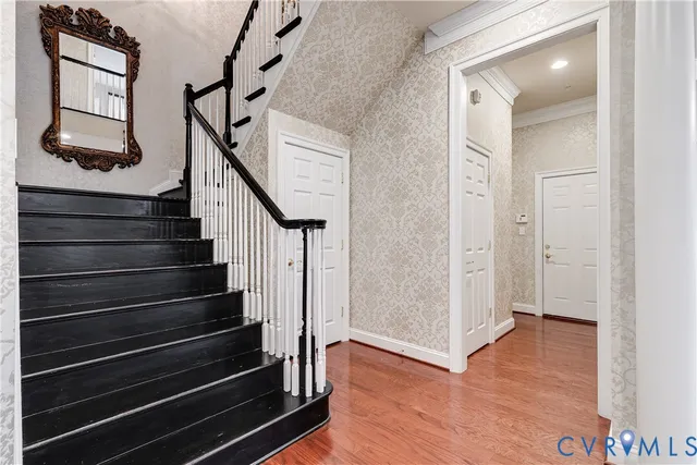 a kitchen with granite countertop a stove a sink and a granite counter tops with wooden floors