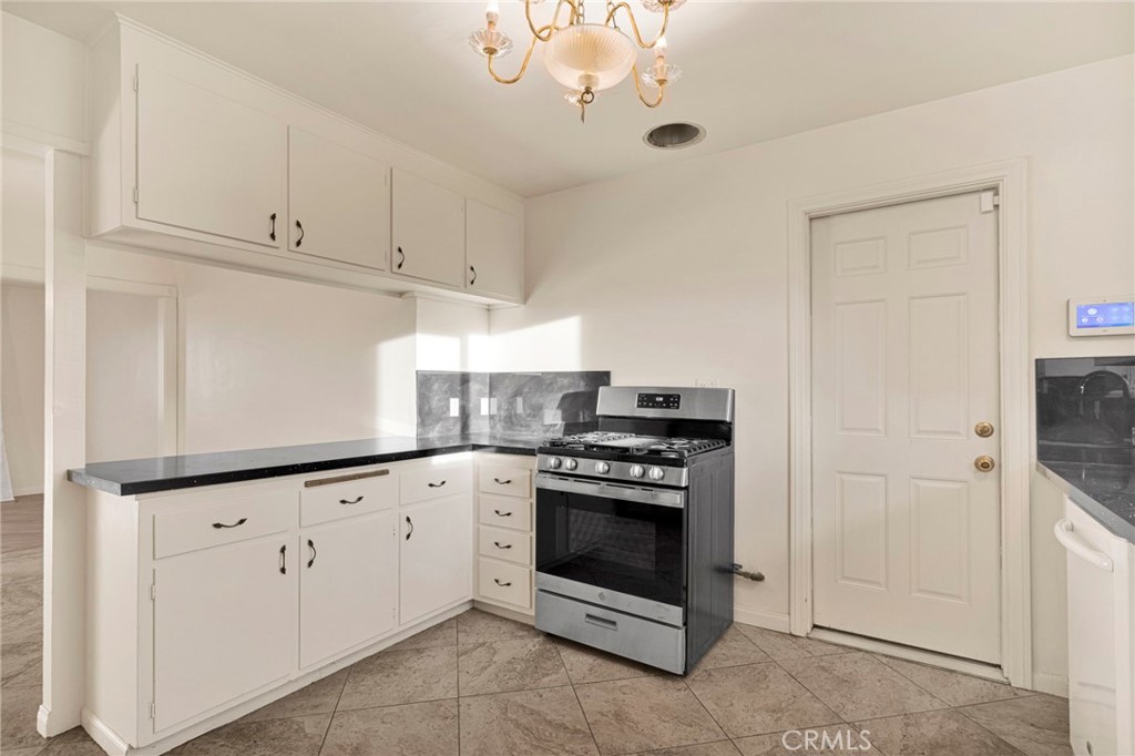 15177 Mendota Road North Apple Valley, CA 92307 - Photo 10 of 50 a kitchen with white cabinets and white appliances
